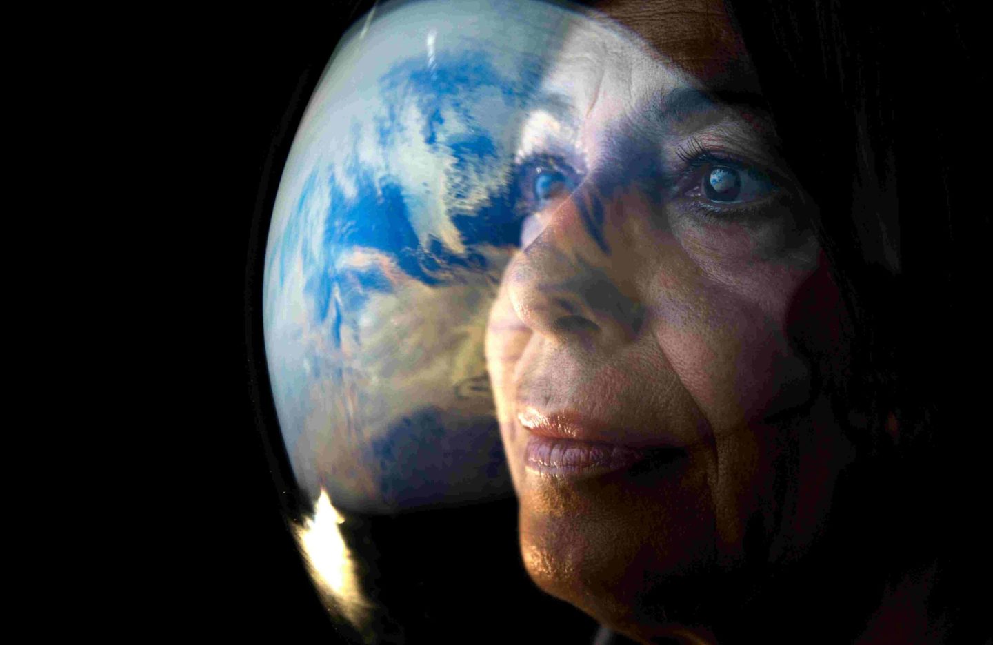 portrait-adult-female-astronaut-looking-planet-earth